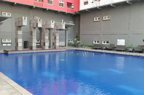 Photo 1 - Homey 1BR with Spacious Living Room and Sofa Bed Green Pramuka Apartment