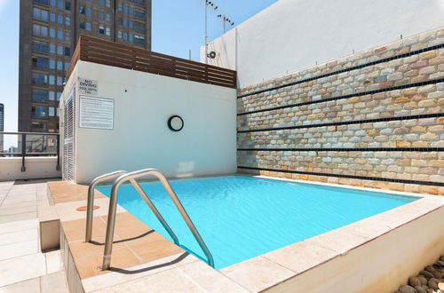 Photo 16 - Stylish Apartment with Rooftop Pool & City Views