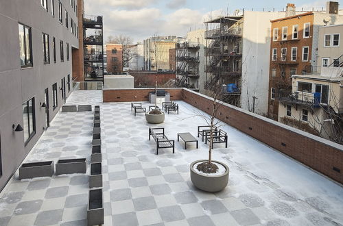 Photo 17 - Stylish 2 BR w Roof Deck Access - Mins to NYC