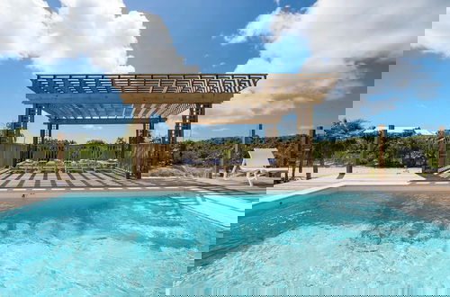 Photo 16 - Tropical Haven: Luxurious Home Steps From Beach