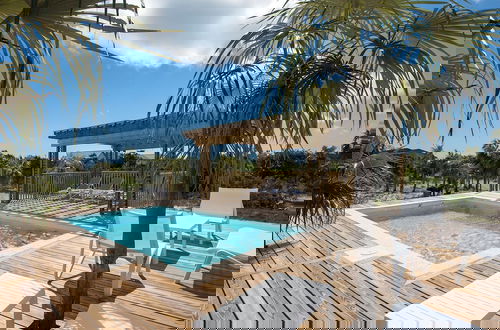 Photo 17 - Tropical Haven: Luxurious Home Steps From Beach