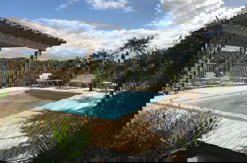 Photo 14 - Tropical Haven: Luxurious Home Steps From Beach