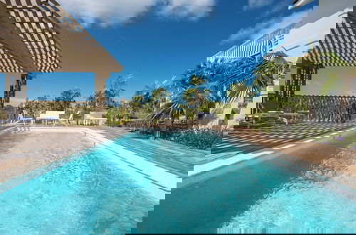 Photo 15 - Tropical Haven: Luxurious Home Steps From Beach