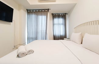 Photo 2 - Cozy And High Floor Studio Room At Vida View Makassar Apartment