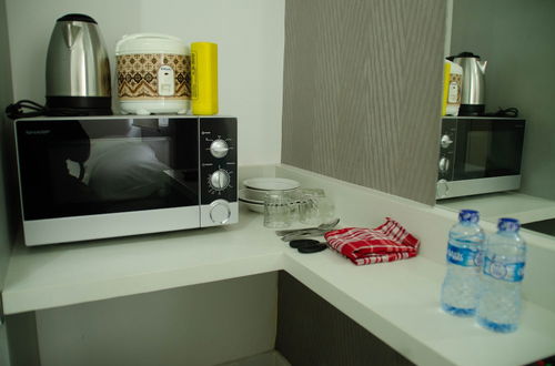 Photo 6 - Cozy Studio Apartment At Aeropolis Residence Near Cgk Airport