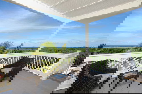 Photo 14 - Coastal Haven: Charming Beachfront Cottage With Pool