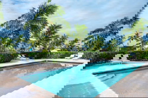 Photo 8 - Coastal Haven: Charming Beachfront Cottage With Pool