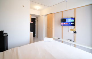 Photo 1 - Simple And Tidy Studio Apartment At Suncity Residence