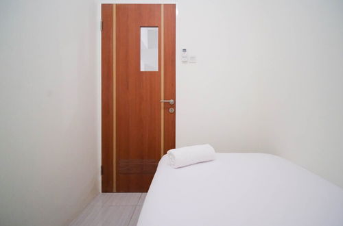 Photo 2 - Cozy Living And Tidy 2Br At Puncak Dharmahusada Apartment