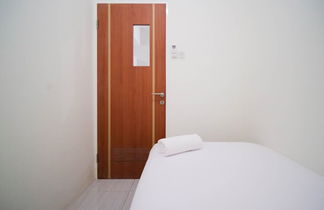 Photo 2 - Cozy Living And Tidy 2Br At Puncak Dharmahusada Apartment