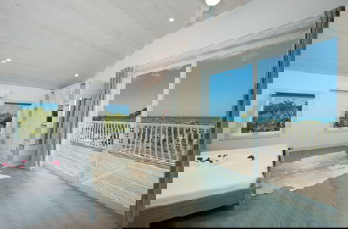 Photo 3 - Tropical Haven: Luxurious Home Steps From Beach